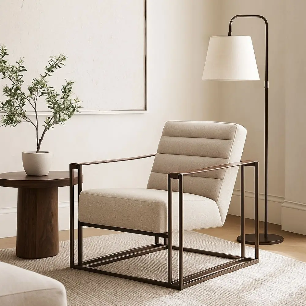 Modern accent chair with beige channeled upholstery, open iron frame, and wooden arm inlays