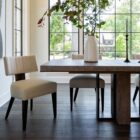 Loleta Side Chair with cream seat upholstery, channeled backrest, and tapered dark wood legs.