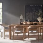 A minimalist rectangular wood dining table with soft-rounded edges and natural grain finish, shown in a studio-style background.