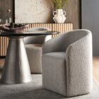 Marlow Dining Chair in soft grey fabric with modern curved silhouette.