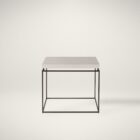 Minimalist end table with a white textured top and thin matte black metal frame.
