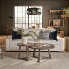 Modern white upholstered apartment sofa with low-profile arms, boxy cushions, and dark wood feet.