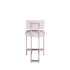 A modern counter stool featuring a soft upholstered back and seat in a neutral woven fabric, supported by a sleek polished metal frame with a footrest.