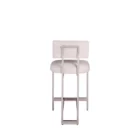 A modern counter stool featuring a soft upholstered back and seat in a neutral woven fabric, supported by a sleek polished metal frame with a footrest.
