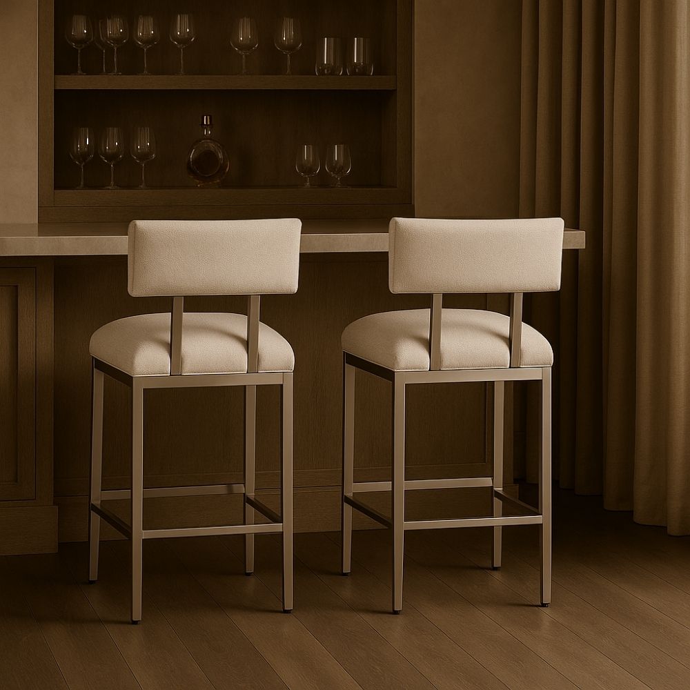 A modern counter stool featuring a soft upholstered back and seat in a neutral woven fabric, supported by a sleek polished metal frame with a footrest.