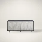 A long, low-profile entertainment console with a textured light wood front and contrasting black frame and top.