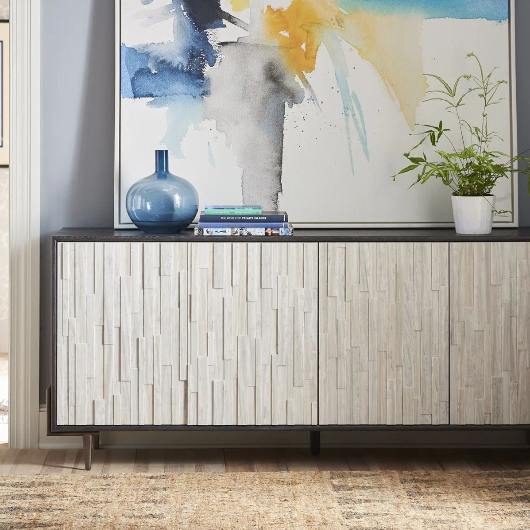 A long, low-profile entertainment console with a textured light wood front and contrasting black frame and top.