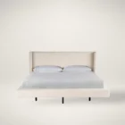 Sainte-Anne Upholstered Bed in a soft neutral fabric with modern wingback headboard and floating platform design.