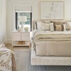 Sainte-Anne Upholstered Bed in a soft neutral fabric with modern wingback headboard and floating platform design.