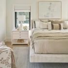 Sainte-Anne Upholstered Bed in a soft neutral fabric with modern wingback headboard and floating platform design.