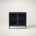 A sleek, short black metal kitchen cabinet with two glass doors, gold-tone handles, and a minimalist open base.