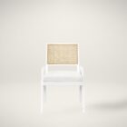Sonora Arm Chair featuring a white wood frame, woven rattan backrest, and soft upholstered seat in neutral fabric.