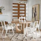 Sonora Arm Chair featuring a white wood frame, woven rattan backrest, and soft upholstered seat in neutral fabric.