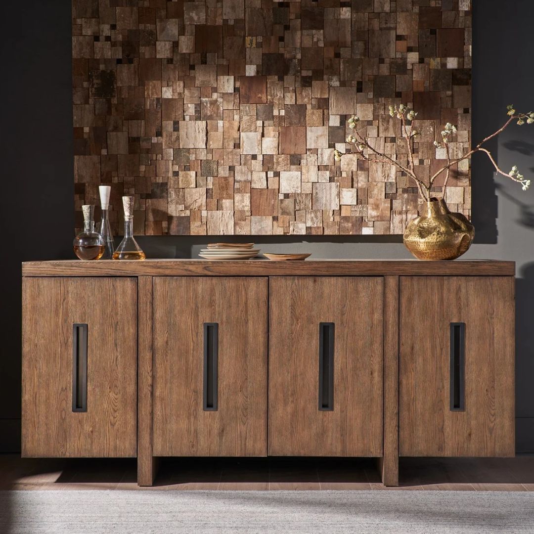 A modern wooden credenza with a warm walnut finish and four cabinet doors, each featuring a vertical rectangular glass inset for subtle transparency.