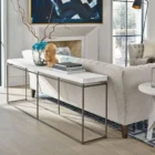 Minimalist console table with a white textured top and ultra-thin black metal frame in a rectangular silhouette.