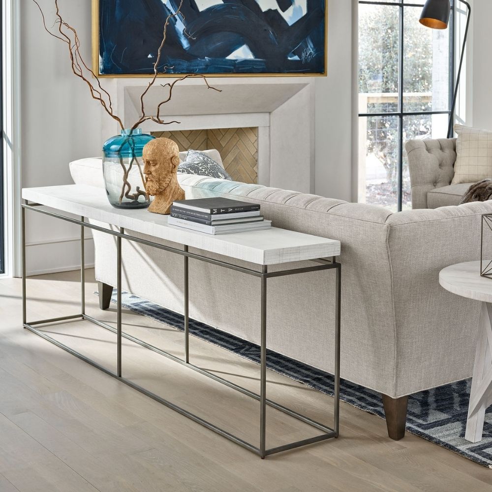 Minimalist console table with a white textured top and ultra-thin black metal frame in a rectangular silhouette.