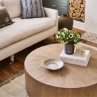 Round solid wood cocktail table with a drum silhouette and sunburst wood grain top pattern.