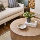 Round solid wood cocktail table with a drum silhouette and sunburst wood grain top pattern.
