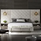 A contemporary nightstand featuring a light wood frame, open shelf, and single drawer with minimalist cut-out handle.