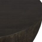 Round black coffee table with a smooth, matte finish and softly curved base in a minimalist drum silhouette