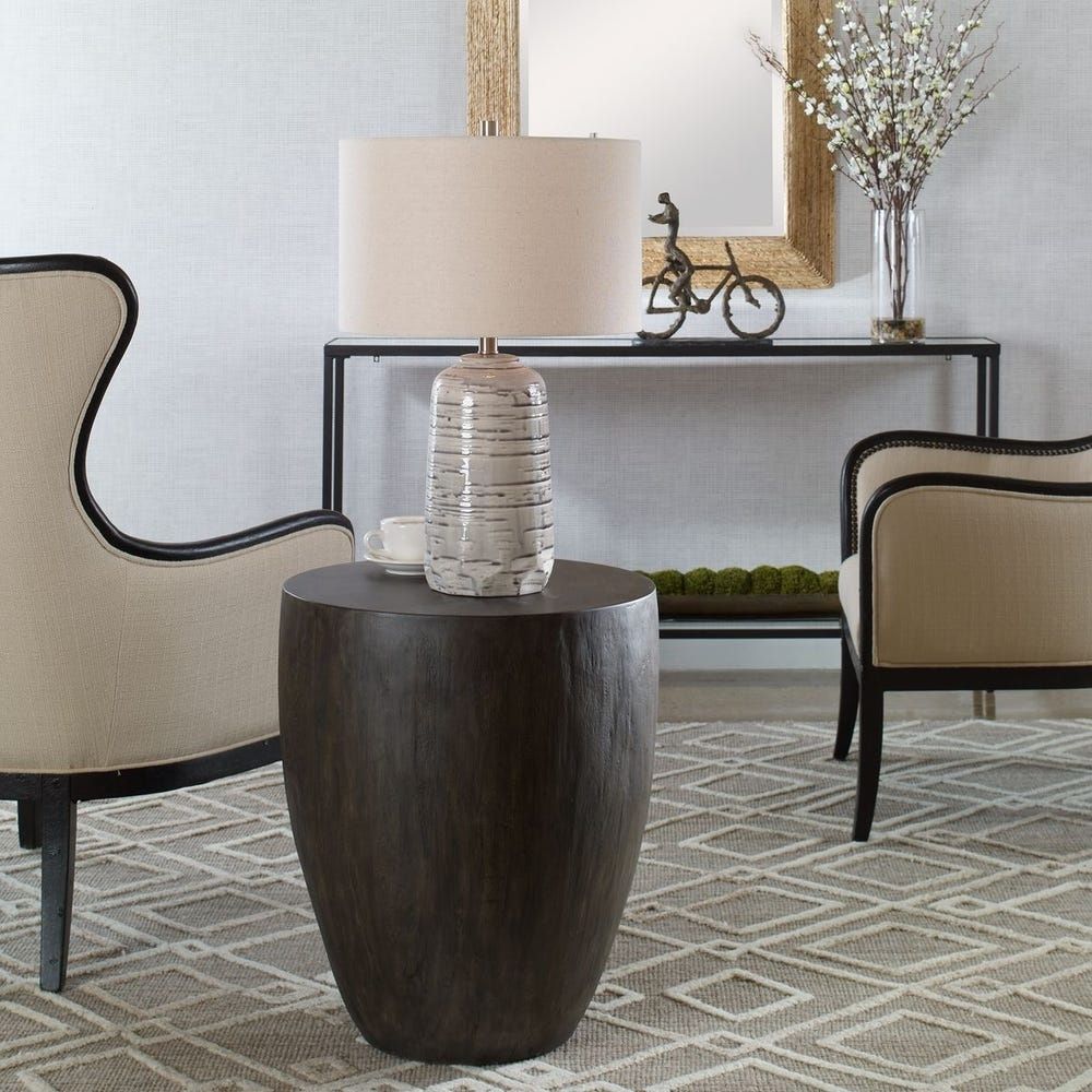 Dark-stained, barrel-shaped wood end table with a smooth, rounded silhouette.