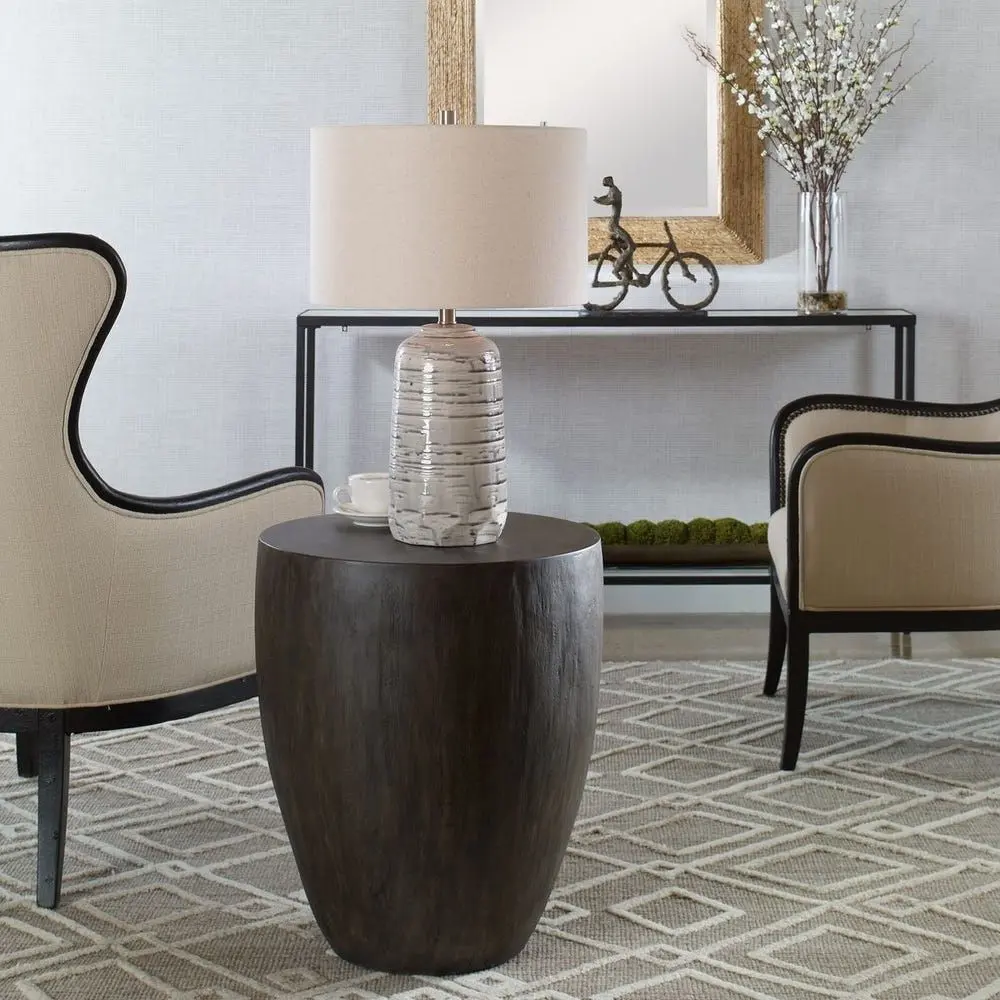Dark-stained, barrel-shaped wood end table with a smooth, rounded silhouette.