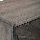 Dark wood two-door cabinet with sunburst carved front panel and modern rectangular handles.