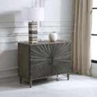 Dark wood two-door cabinet with sunburst carved front panel and modern rectangular handles.