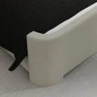 The Tilburg Bed featuring a high, fully upholstered headboard and footboard in a soft neutral fabric with a clean, curved silhouette.The Tilburg Bed featuring a high, fully upholstered headboard and footboard in a soft neutral fabric with a clean, curved silhouette.