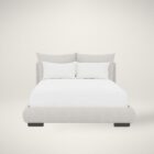 Upholstered Bed with Double-Cushion Headboard and Rounded Base, Dressed in Neutral Bedding.
