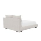 Upholstered Bed with Double-Cushion Headboard and Rounded Base, Dressed in Neutral Bedding.