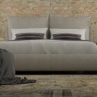 Upholstered Bed with Double-Cushion Headboard and Rounded Base, Dressed in Neutral Bedding.