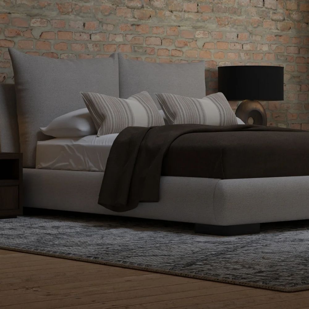 Upholstered Bed with Double-Cushion Headboard and Rounded Base, Dressed in Neutral Bedding.