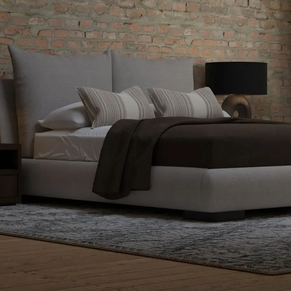 Upholstered Bed with Double-Cushion Headboard and Rounded Base, Dressed in Neutral Bedding.