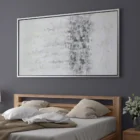 Abstract wall art featuring a softly blended palette of whites, greys, and subtle metallics, framed in a slim black frame.