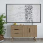 Abstract wall art featuring a softly blended palette of whites, greys, and subtle metallics, framed in a slim black frame.