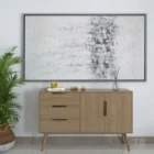 Abstract wall art featuring a softly blended palette of whites, greys, and subtle metallics, framed in a slim black frame.