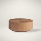 Round solid wood cocktail table with a drum silhouette and sunburst wood grain top pattern.