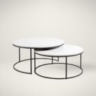 Set of two round nesting coffee tables with white marble tops and thin black metal bases, shown partially stacked.
