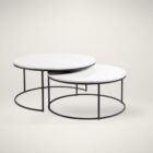 Set of two round nesting coffee tables with white marble tops and thin black metal bases, shown partially stacked.
