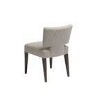 The Aniston Dining Chair featuring a sculpted mid-back silhouette, textured neutral upholstery, and tapered wood legs for a refined yet relaxed look.