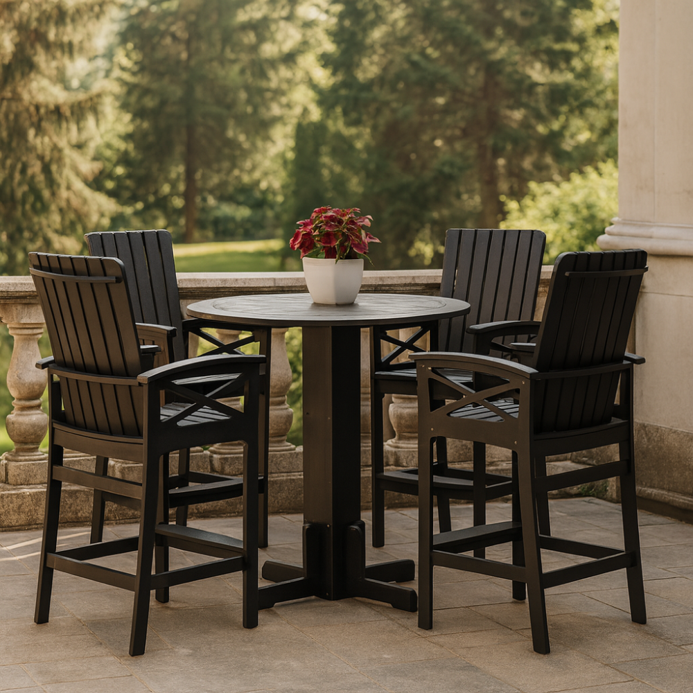 Outdoor round bistro table with four matching high-back chairs in black wood finish, styled with a white planter and red foliage, set on a stone patio overlooking lush greenery. beaver springs furniture