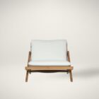 Outdoor lounge chair with angled wood frame and plush white cushions.