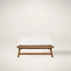 Outdoor teak stool with white cushion and slatted wood frame.