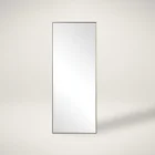 A modern full-length rectangular mirror with a slim metallic frame and a minimalist design.