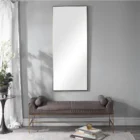 A modern full-length rectangular mirror with a slim metallic frame and a minimalist design.