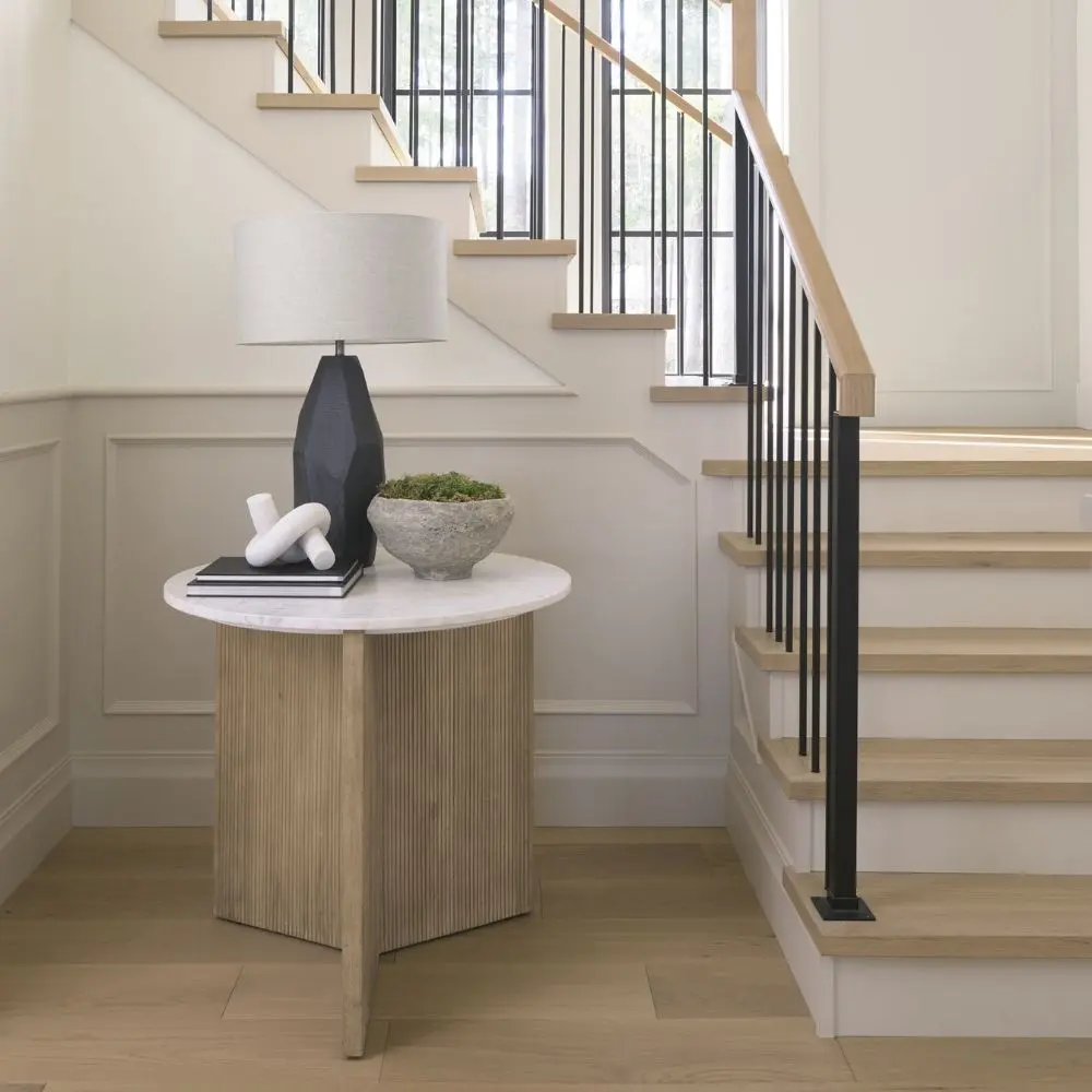 Mercana Enzo end table with a white marble top and fluted wood base in a natural finish.