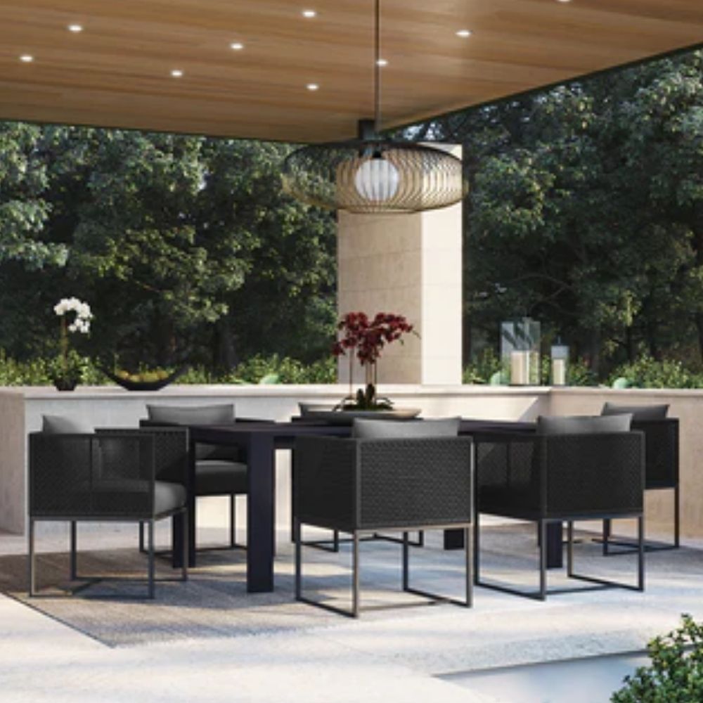 Modern outdoor dining chair with charcoal cushions, black woven frame, and sleek stainless steel base.