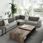 A modern modular sectional sofa in neutral beige with a built-in walnut storage table and chaise lounge.