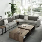 A modern modular sectional sofa in neutral beige with a built-in walnut storage table and chaise lounge.
